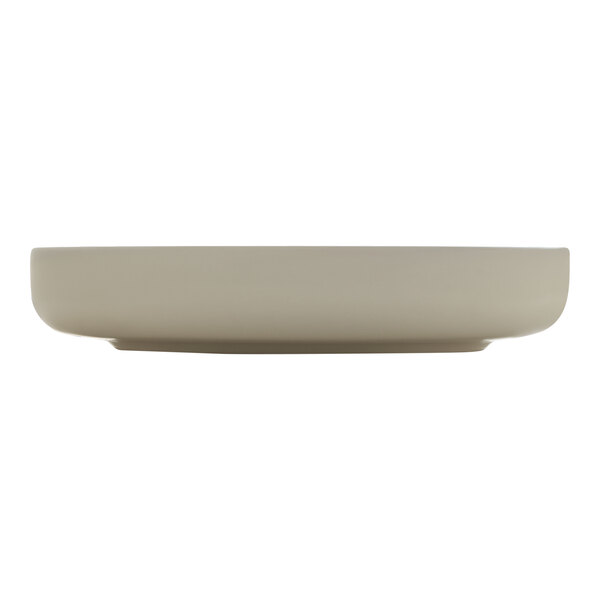 A beige porcelain deep raised rim plate.