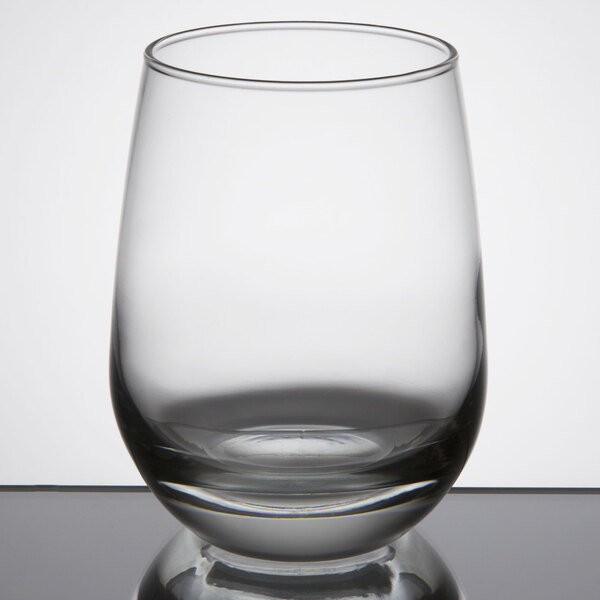 A clear, stemless white wine glass with a rounded bowl and a capacity of 15.25 ounces.