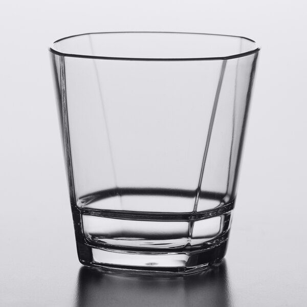 A clear, stackable 12 oz. plastic double rocks or old fashioned glass with a modern, angular design.