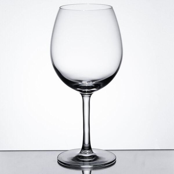 A clear balloon-shaped wine or cocktail glass with a long stem.