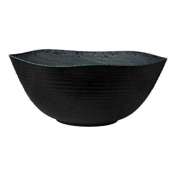 A large, round, slate-colored melamine bowl with a textured exterior and wavy rim.
