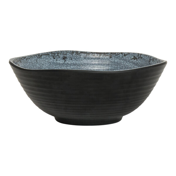 A round, slate-colored melamine bowl with a textured blue interior.