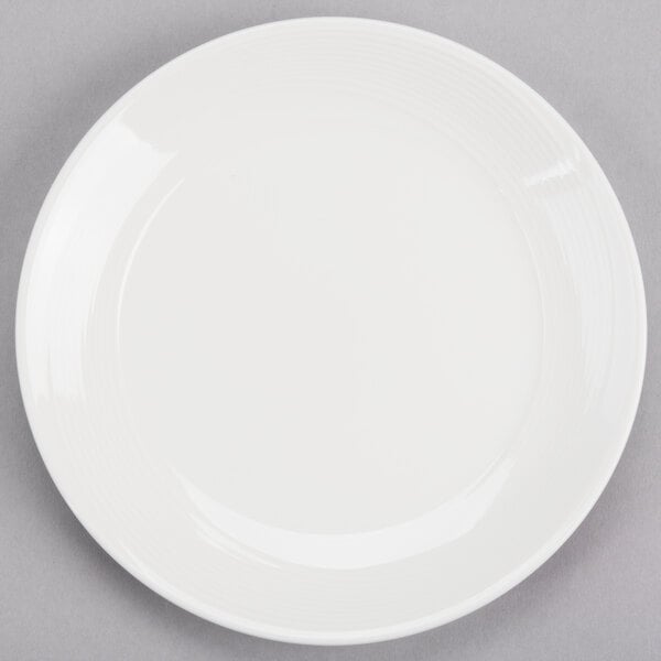 A plain white round porcelain coupe plate.