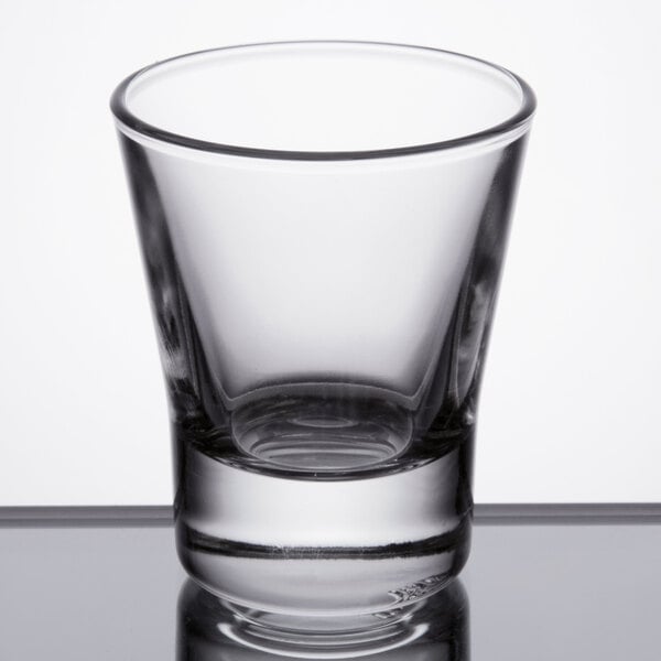 A clear, empty 2.25 oz. shot glass with a thick base and slightly flared sides.