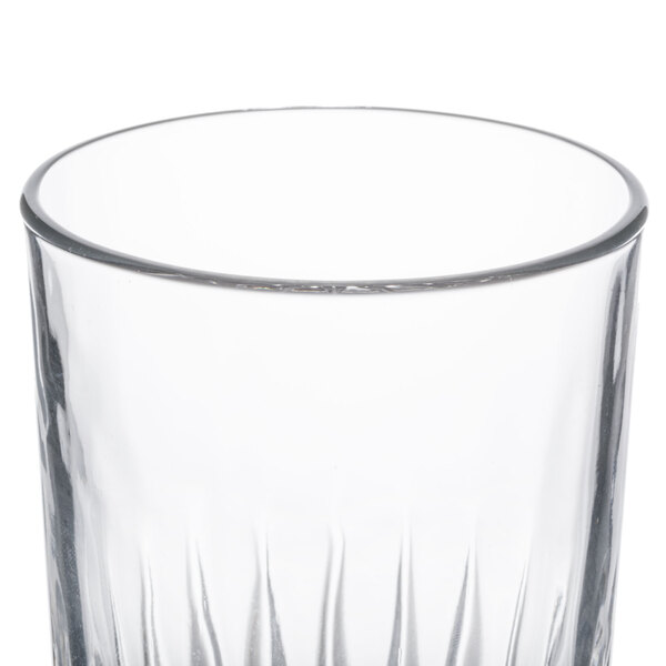 A clear Libbey Winchester 16 oz. cooler glass with a slightly flared rim and vertical pattern.