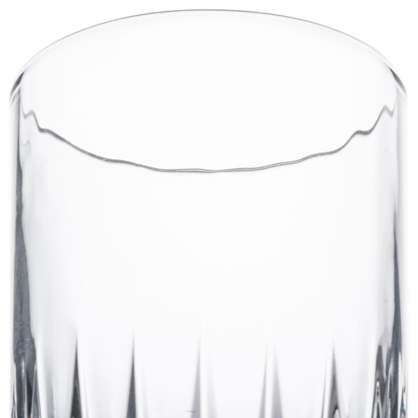 A clear Libbey Winchester 16 oz. cooler glass with a slightly flared rim and vertical facets.