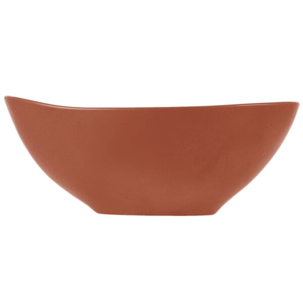 A matte clay-colored porcelain bowl with an organic, curved shape.