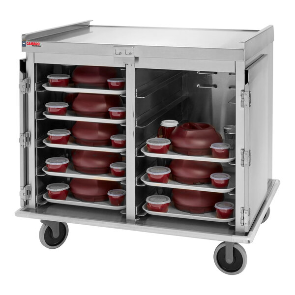 A stainless steel meal delivery cart with multiple trays holding covered dishes and containers.