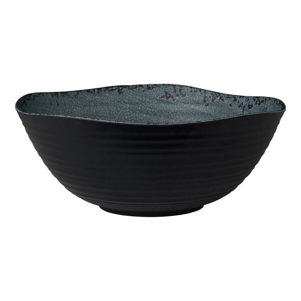 A round, slate-colored melamine bowl with a textured interior and a wavy rim.