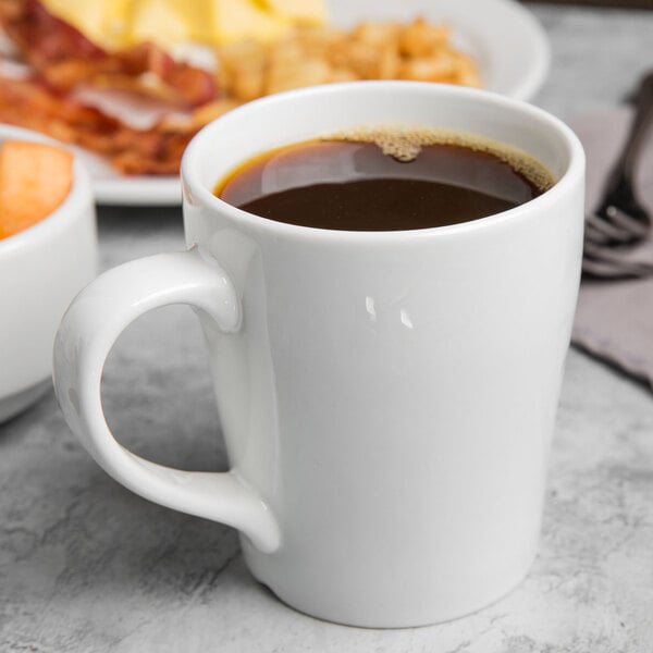 A white porcelain mug filled with black coffee.