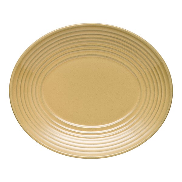 A tan oval terracotta platter with a ridged design around the edge.