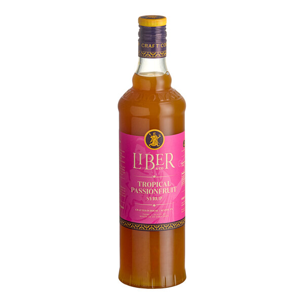 A 750 mL bottle of Liber & Co Tropical Passionfruit Syrup with a pink label.