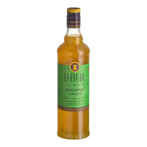 A 750 mL bottle of Liber & Co Pineapple Gum Syrup with a green label.