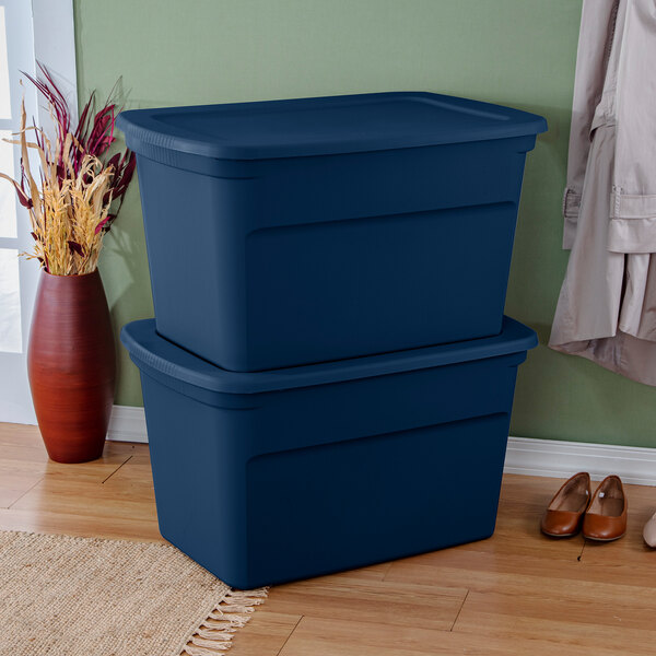 A pair of large marine blue plastic storage totes with lids stacked on top of each other.