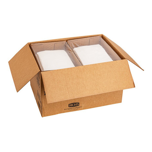 A cardboard box containing two packages of white cake with buttercreme icing.