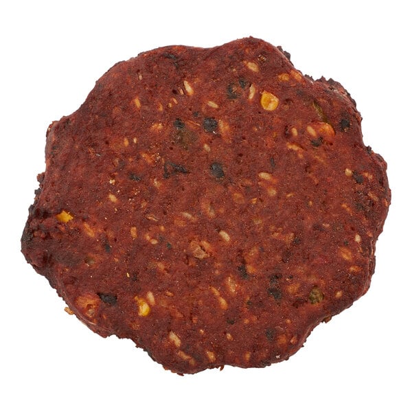 A round, dark brown chipotle black bean burger patty with visible pieces of beans and vegetables.