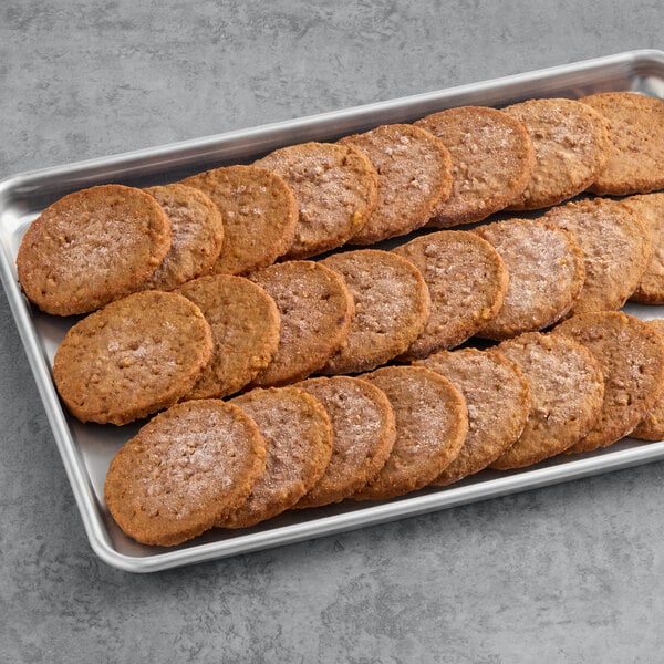 A tray of round, plant-based vegetarian burger patties arranged in rows.