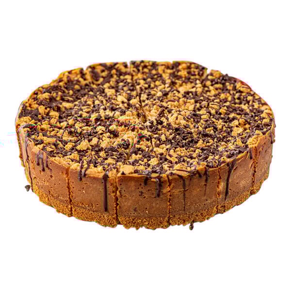 A pre-cut chocolate chip cannoli ricotta cheesecake topped with chocolate and crunchy bits.