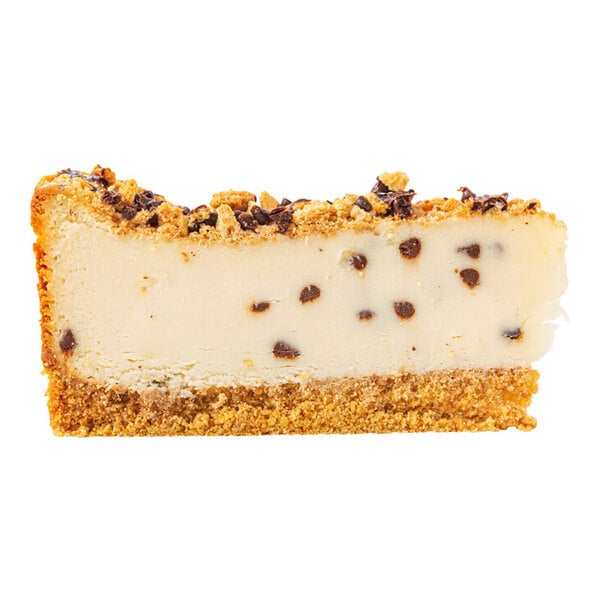 A slice of chocolate chip cannoli ricotta cheesecake with a graham cracker crust and chocolate chips throughout.