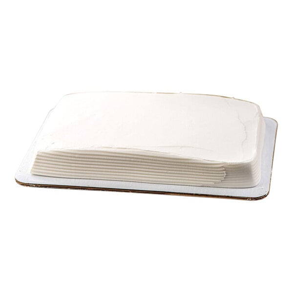 A rectangular chocolate cake with white buttercreme icing on a tray.