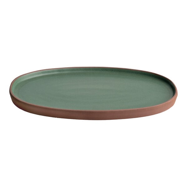 An oval stoneware tray with a green surface and high terracotta-colored rim.