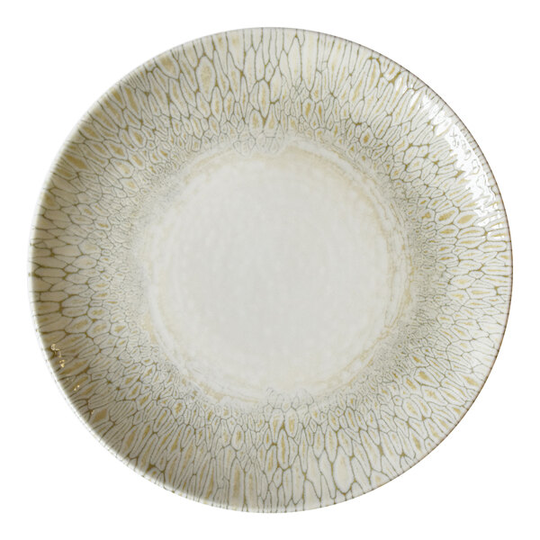 A beige china coupe plate with a textured, patterned rim.