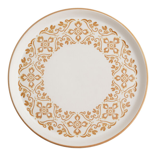 A round stoneware plate with a sand-colored floral and scrollwork pattern around the rim.