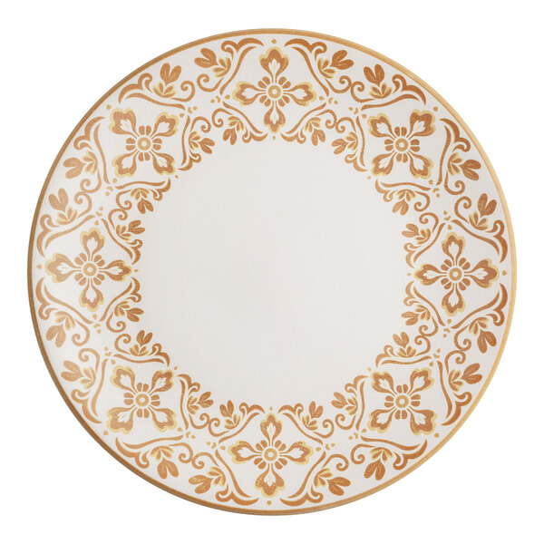 A round stoneware plate with a gold floral and scroll pattern around the rim.