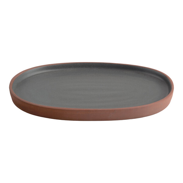 A gray high rim oval stoneware tray with a terracotta-colored edge.