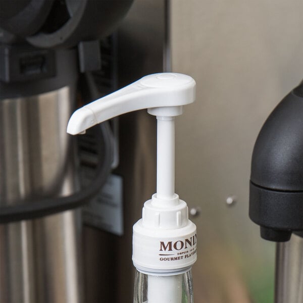 A white plastic syrup pump designed for use with 750 mL bottles.
