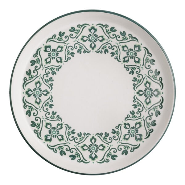A round stoneware plate with a forest green floral and scroll pattern around the rim.