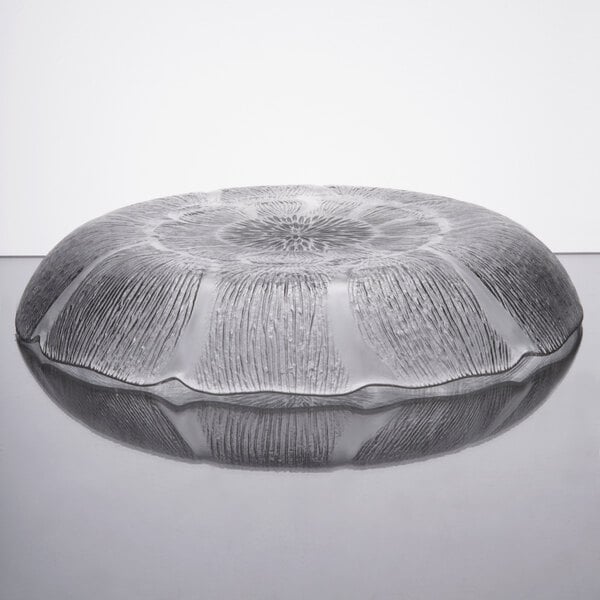 An Arcoroc Fleur glass bowl on a table.