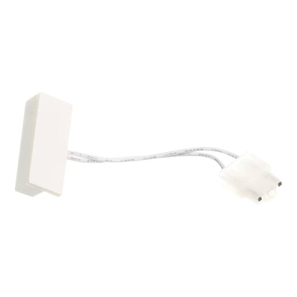 An Ice-O-Matic magnetic reed switch with a white rectangular sensor and attached wiring.