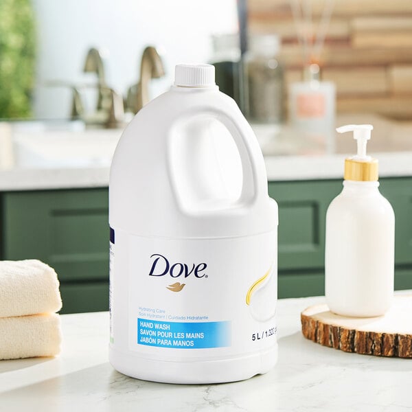 A large 5-liter container of Dove Hydrating Care hand wash placed on a bathroom counter.