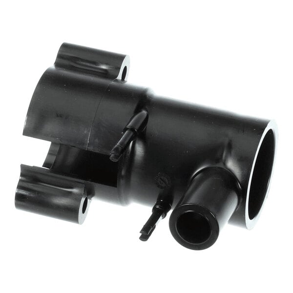 A black plastic shuttle housing component for Follett Corporation equipment.