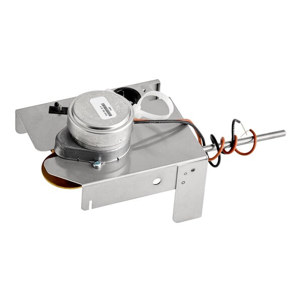 A metal Ice-O-Matic harvest kit with attached wiring and components.