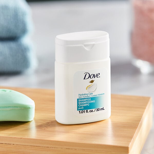 A small 1.01 fl. oz. bottle of Dove Hydrating Care shampoo designed for hotel and motel use.