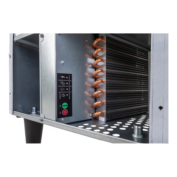 A close-up view of the internal components of a Scotsman 15-inch air-cooled undercounter nugget ice machine with a 36 lb. bin.