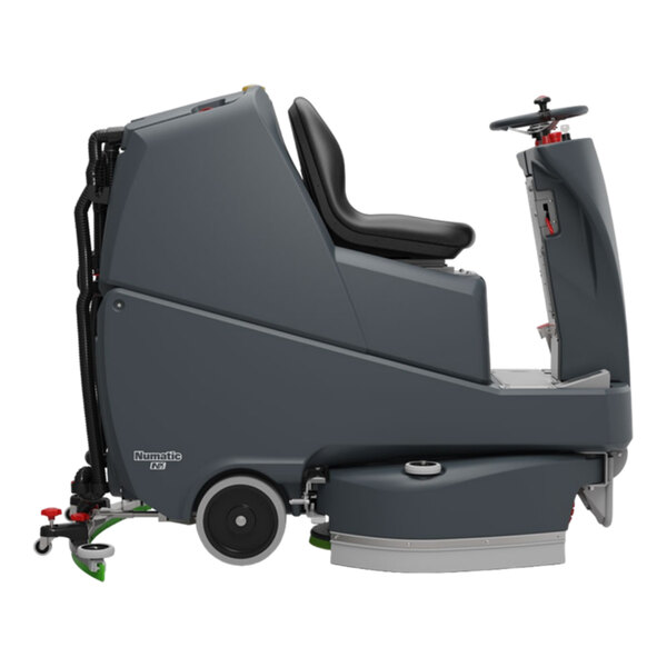 A large, dark gray ride-on floor scrubber machine with a seat, steering wheel, and cleaning components underneath.