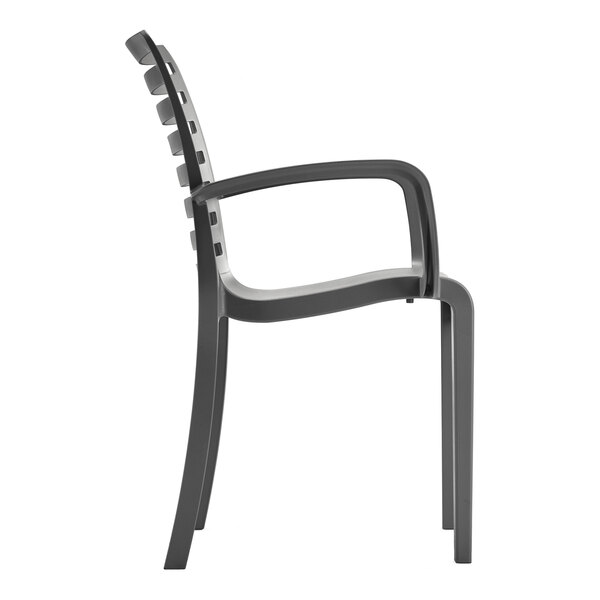 A charcoal-colored resin stackable outdoor arm chair with a slatted back and armrests.