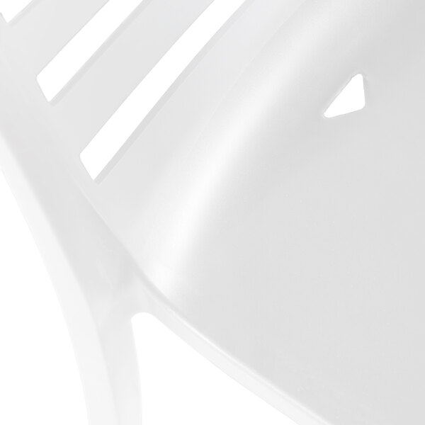 A white resin stackable outdoor side chair with a slatted back and a contoured seat.