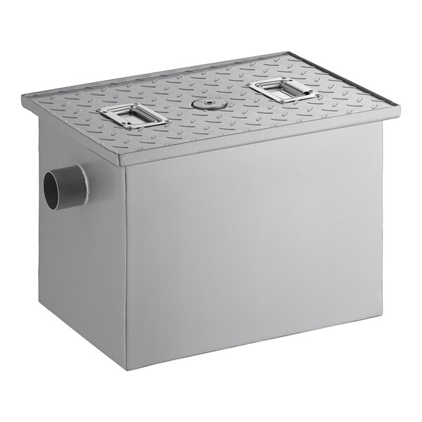A rectangular metal grease trap with a textured lid and two non-threaded pipe connections.