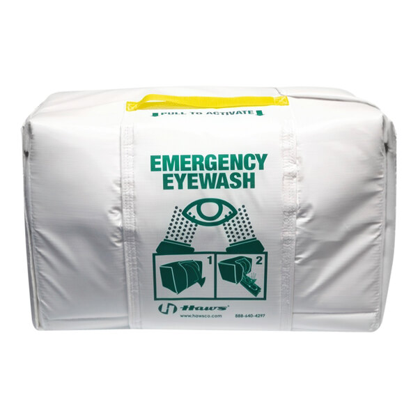 A white heat shield cover for a portable emergency eye and face wash station.