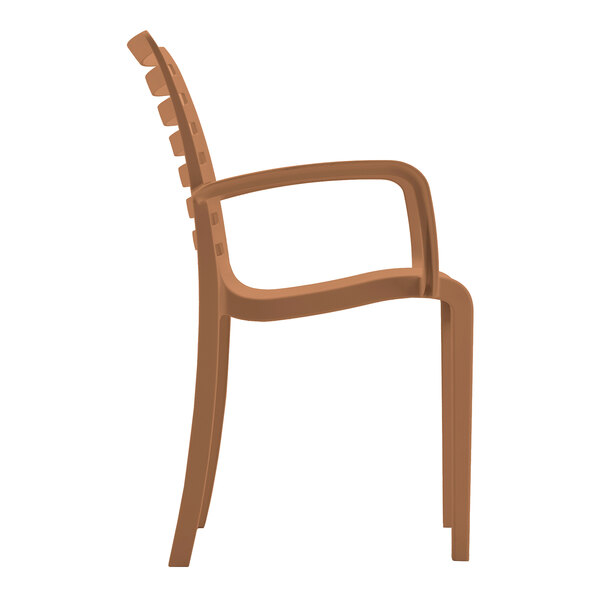 A brown resin stackable outdoor arm chair with a slatted back and curved armrests.