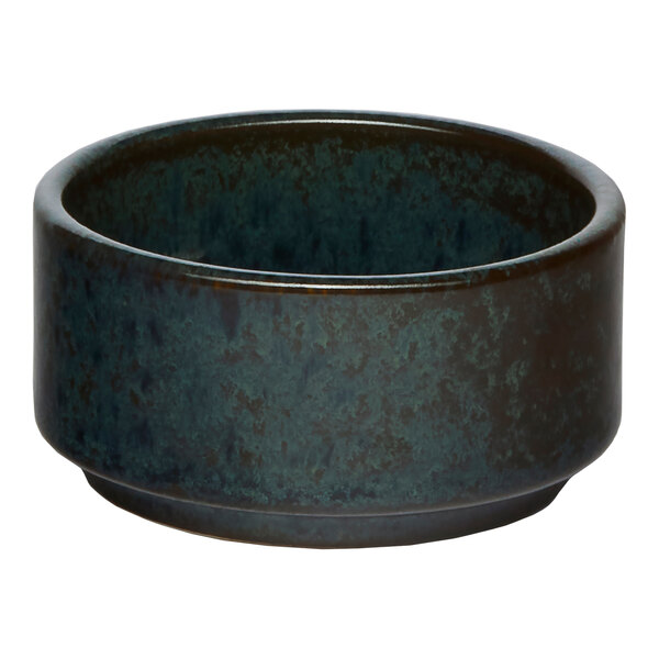 A small, round, black embossed porcelain ramekin.