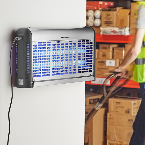 A stainless steel indoor LED insect trap and bug zapper mounted on a wall.