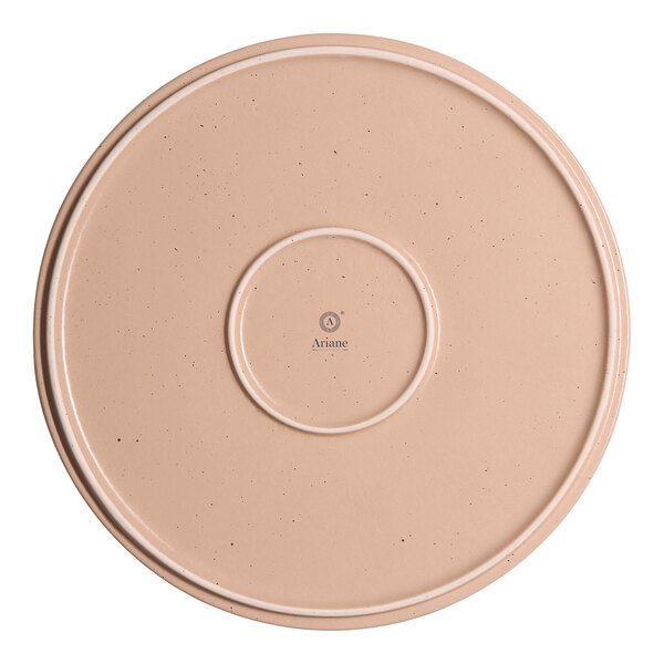 A tan round porcelain plate with a raised rim.