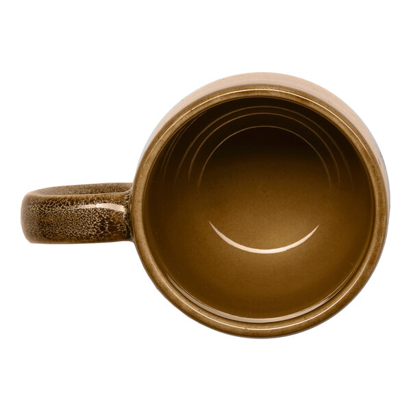 A brown porcelain coupe mug with a handle, viewed from above.