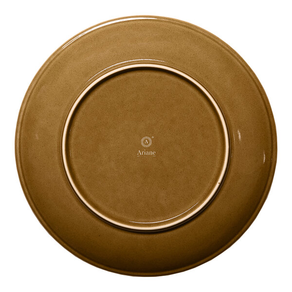 A brown round rimless porcelain coupe plate viewed from the bottom.