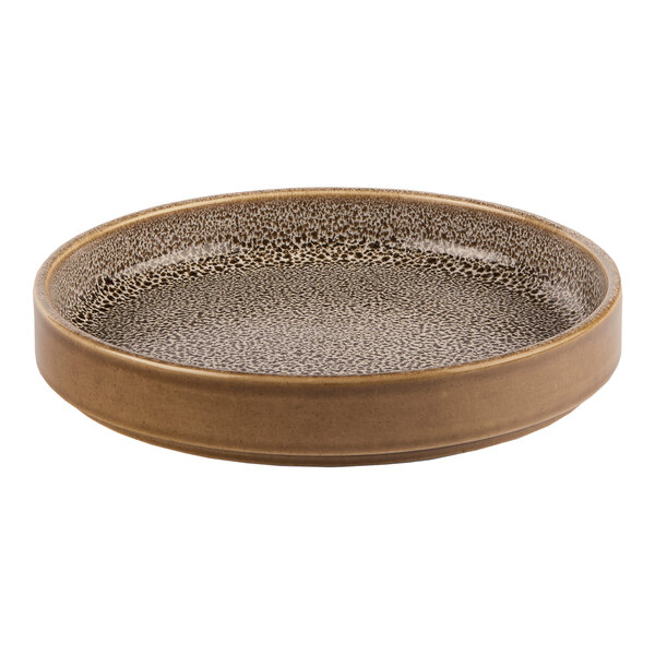 A brown round porcelain plate with a raised rim and a speckled interior pattern.